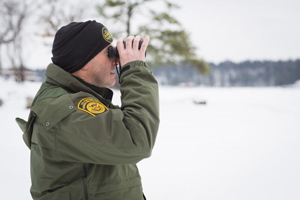 image of border patrol agent with binoculars