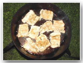 image of pike pieces sizzling in fry pan