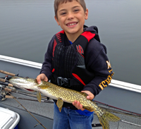 image of young boy holding small pike