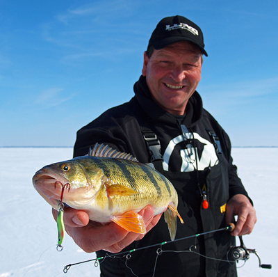 image of Mark Brumbaugh holding jumbo perch on the ice