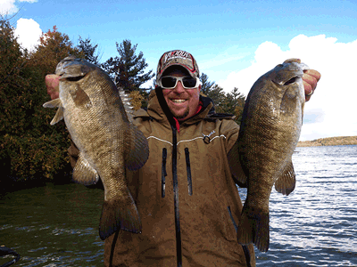 image of Captain Chris Noffsinger with 2 big smallmouth bass