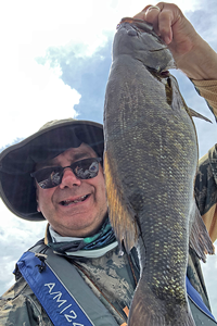 image of bill diehm with giant smallmouth bass