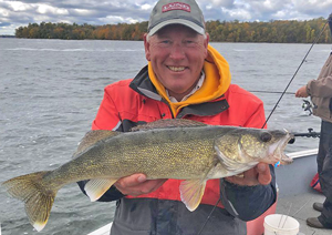 image of professional walleye guide Jeff Sundin holdinfg nice size fish