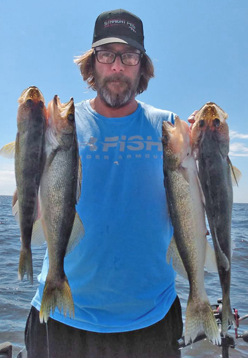 image of walleye angler with limit of fish caught on Lake of the Woods