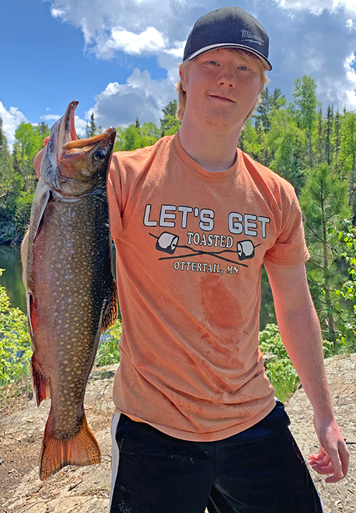 image of angler holding nice trout caught near Ely MN