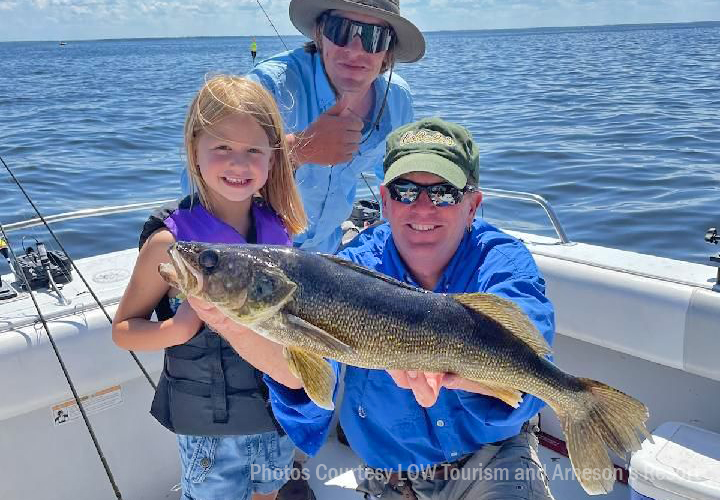 image of Iris with huge lake of the woods walleye