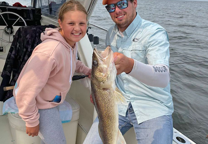 image of Cyrus Resort guide and fishing customer holding big walleye