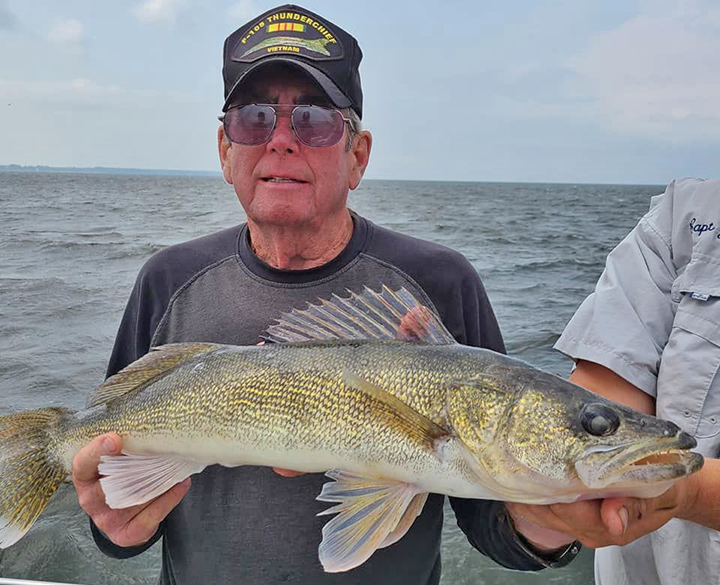 image of veteran holding large walleye caught on lake of the woods