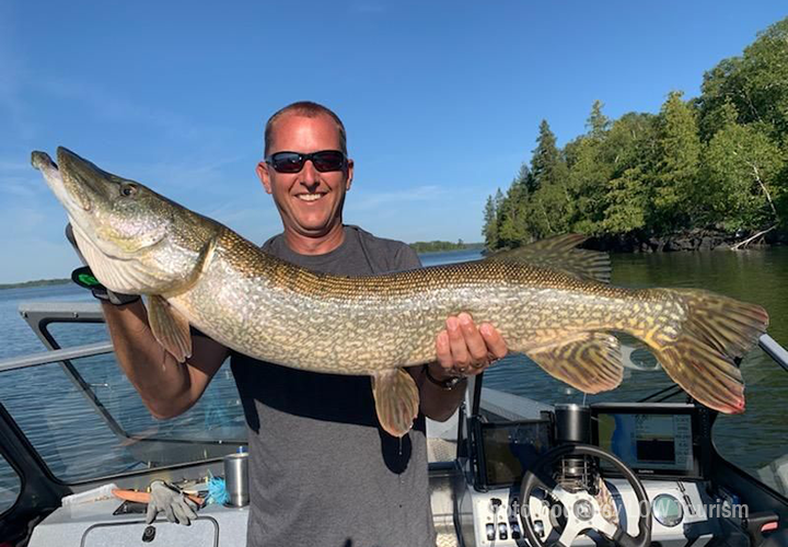 image of angler with huge northern pike caught at lake of the woods
