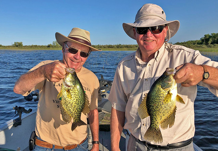 image of John Engler and Jim Moriarity holding big crappies caught near Deer River Minnesota