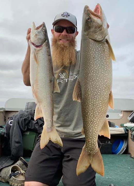 image of man with nic lake trout caught in the Ely MN area