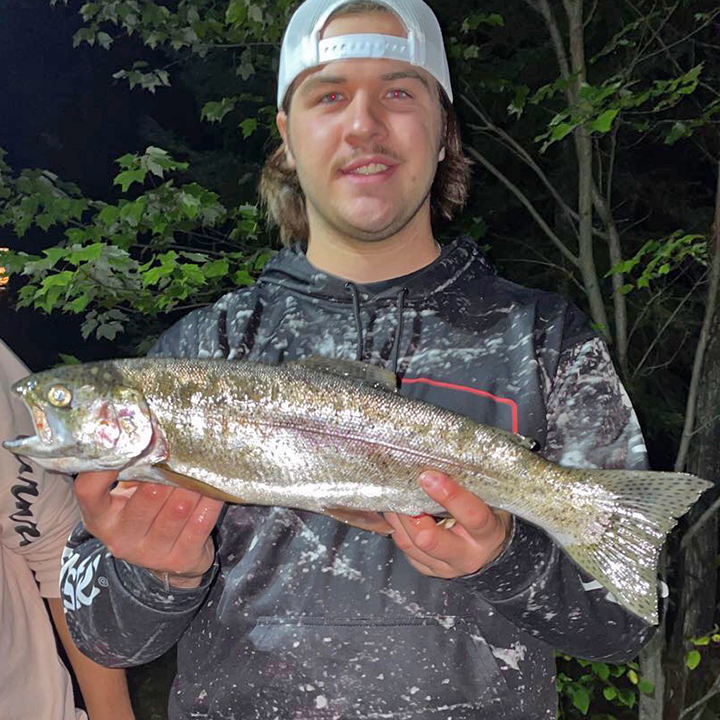 image of young angler holding nice trout