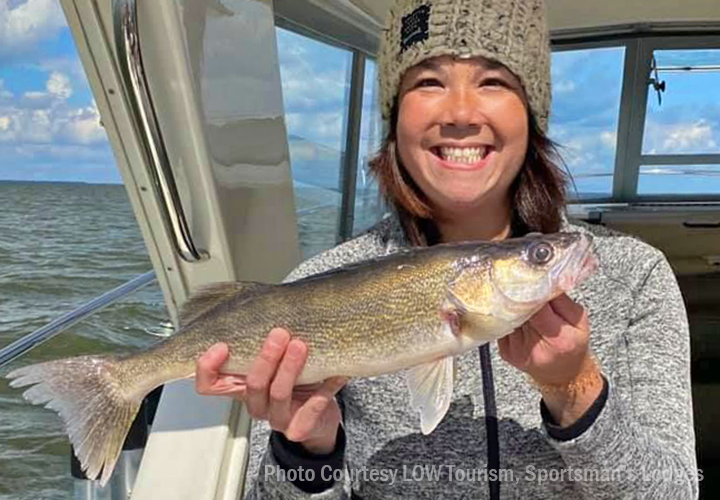 image of woman with nice walleye caught on lake of the woods charter boat