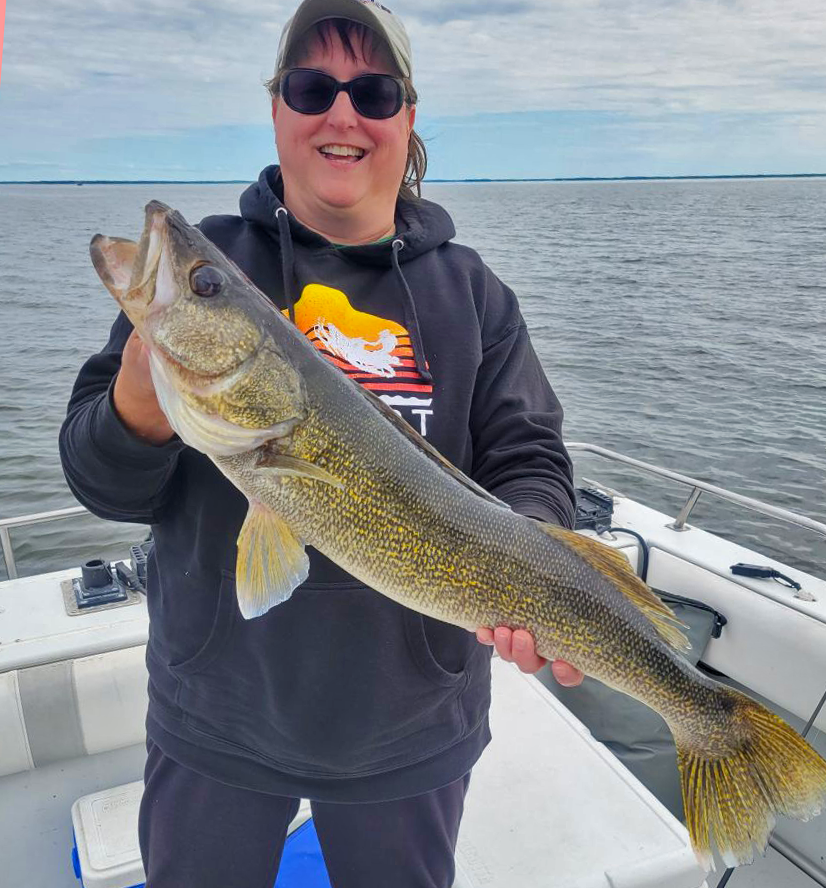 image of woman with huge walleye caught on lake of the woods