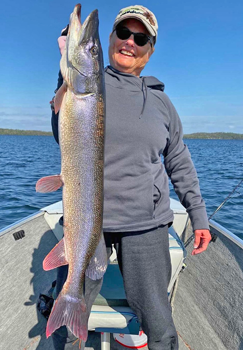 image of woman with big pike caught in the Ely MN region