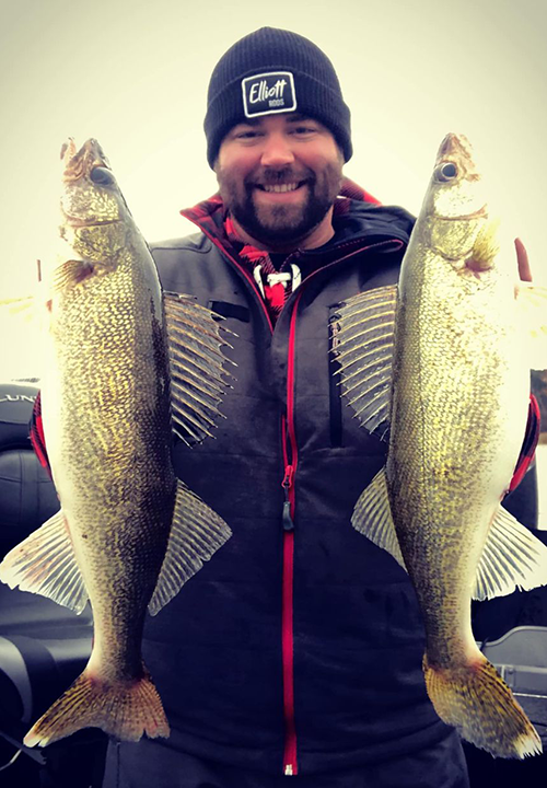 image of Andrew Kraft with 2 big walleyes caught on Lake of the Woods