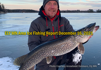 image of ice fisherman holding big northern pike caught in the Ely area