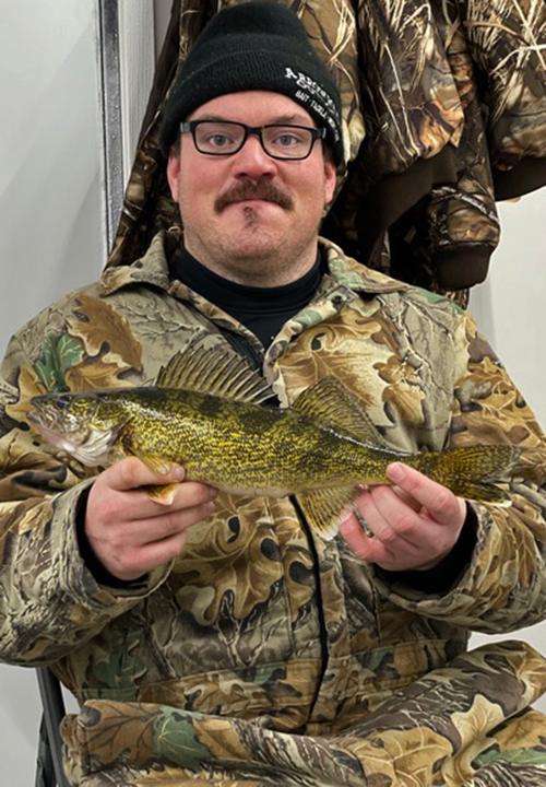 image of ice fisherman holding nice walleye caught in the Ely area.