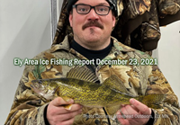 image of ice fisherman holding nice walleye caught in the Ely area.