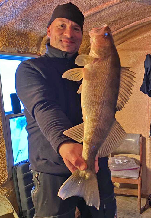 image of angler with huge walleye caught at Flag Island on Lake of the Woods