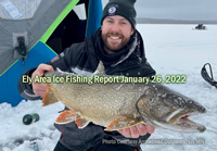 image of ice fisherman holding big trout caught in the Ely MN area