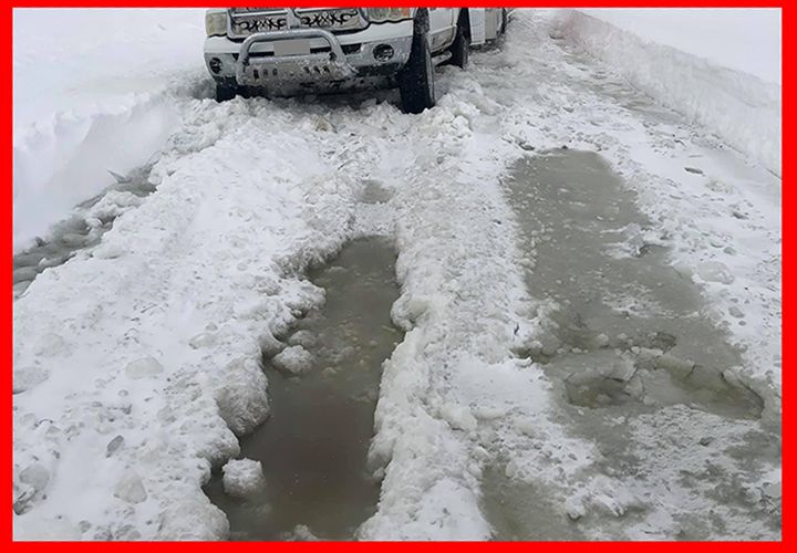 image of pickup truck on ice with lots of wet slush
