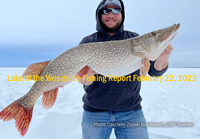 imaqge orf ice fisherman holding huge northern pike from Zippel Bay on Lake of the Woods