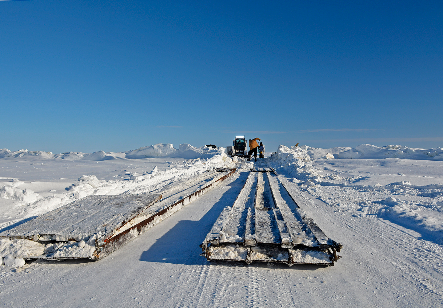 image of the Zippel Bay plow crew installing an ice bridge on an ice road on Lake of the Woods