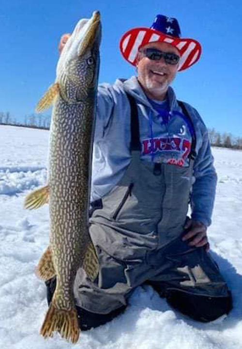 image of ice fisherman with big pike caught at Zippel Bay Resort
