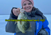 image of the Hippie Chick holding big crappie caught ice fishing near grand rapids