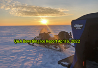 image of snowmobile and portable ice fishing shelter on the ice