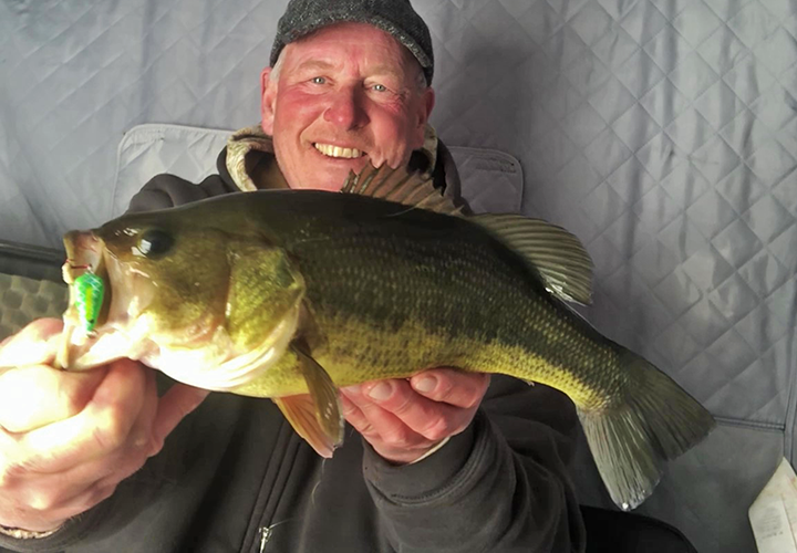 image of largemouth bass caught ice fishing using a Lindy Glow Spoon