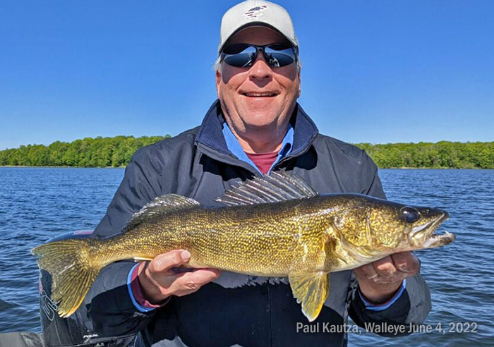 image of paul kautza holding big walleye caught on lake winnie