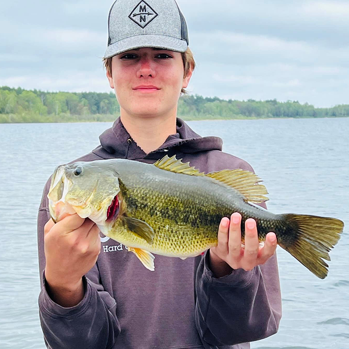 image of young angler holding big bass caught on Lake Winnie