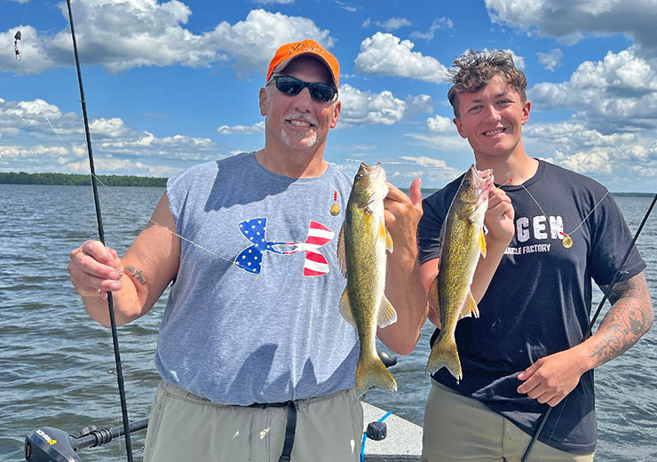 image of Phil Goettl and James Blood holding a pair of walleyes they caught trolling Little Joe Spinners