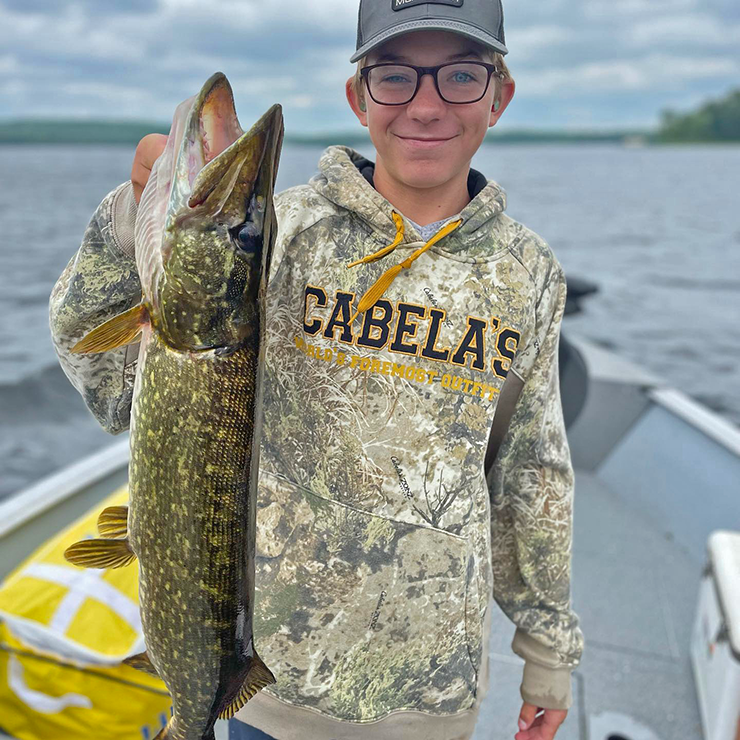 image of Blaine Cheatham holding large northern pike caught on pokegama lake