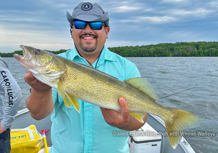 Image of Josh with big winnie walleye caught during thne daikin fish-a-roo