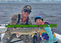 image of charter captain and young girl showing a big walleye caught on aLake of the Woods