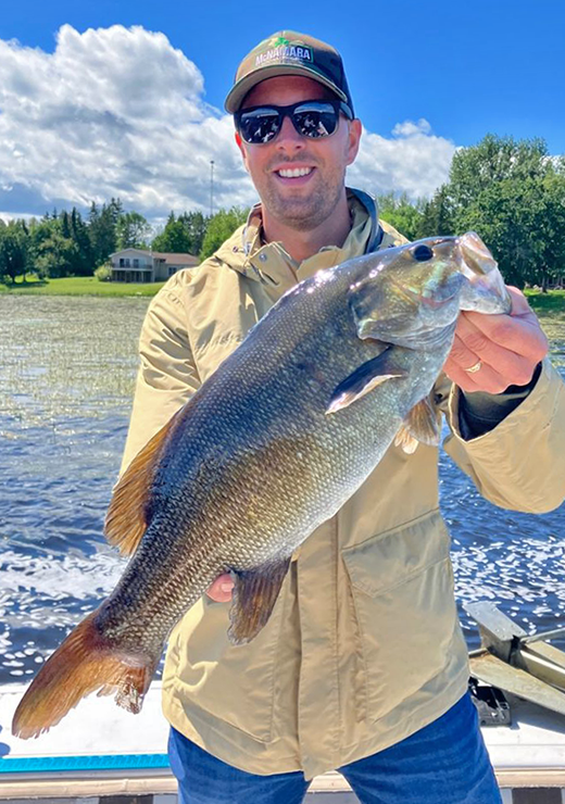 image of angler holding giant smallmouth bass caughton the rainy river