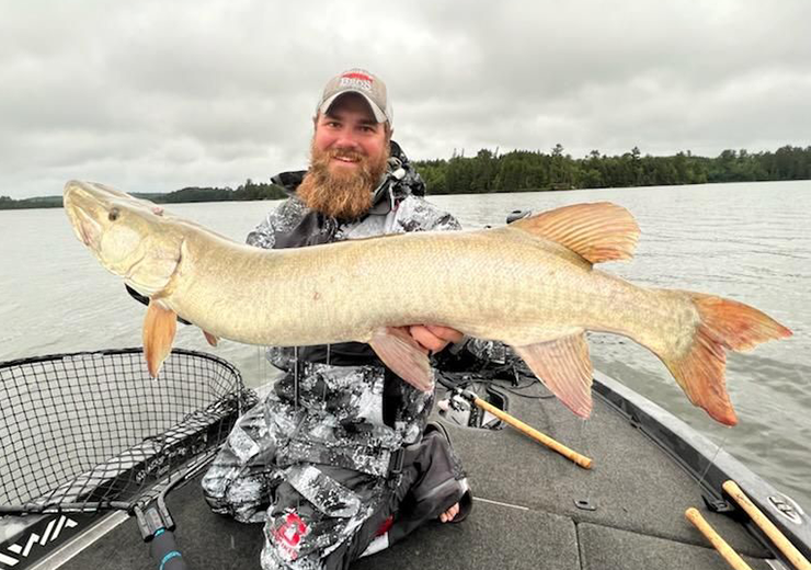 image of angler holding large musky on Lake of the woods
