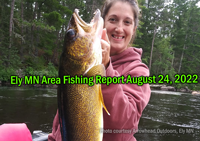 image of woman with gigantic walleye caught near Ely MN