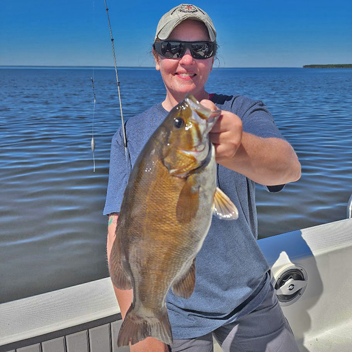 image of Eva Van Langen holding big smallmout4h bass caught on Lake of the Woods 