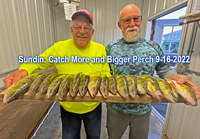 image of Keith Eberhardt and friend Greg with big perch on fillet board