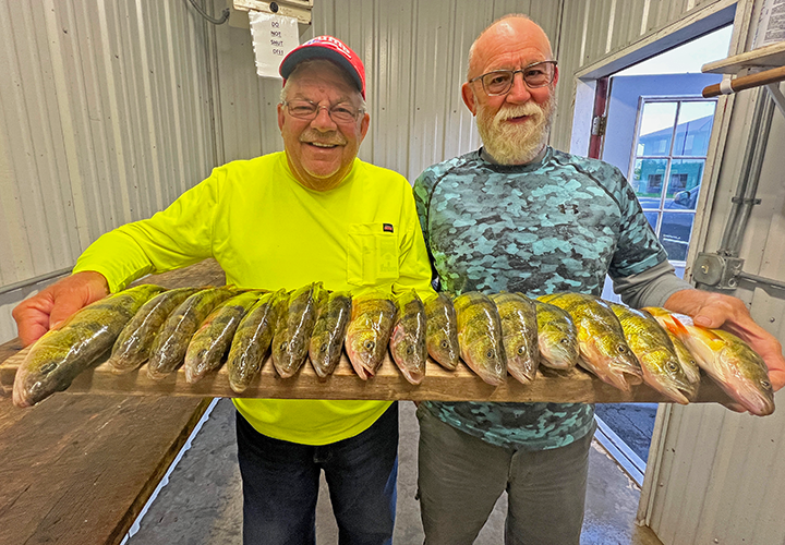 image of Keith Eberhardt and friend Greg with big perch on fillet board
