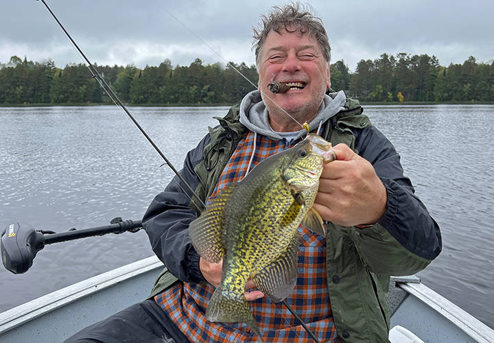 image of Kyle Reynolds holding big crappie caught in the Deer River area