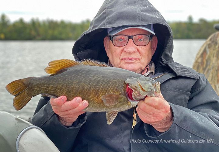 image of man holding nice smallmouth bass caught in the Ely Minnesota area