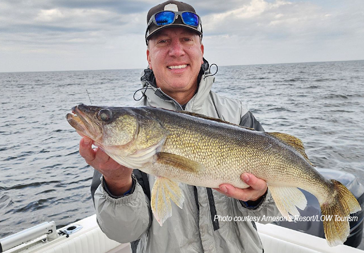 image of angler holding bi walleye caught on lake of the woods