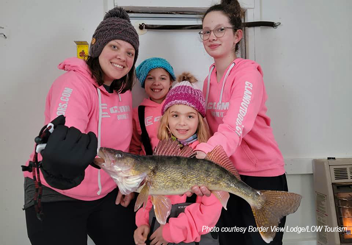 image of young women holding a big walleye caught on Lake of the Woods 