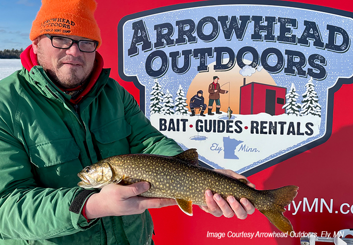 image of ice fisherman holding nice stream caught near Ely Minnesota