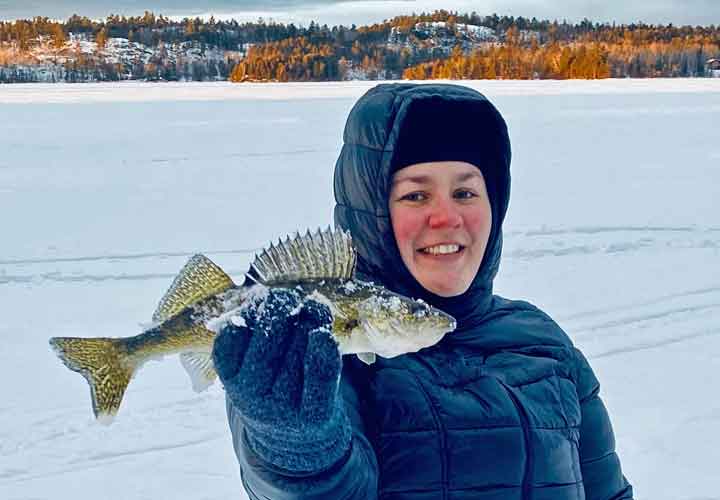 image of woman holding walleye caught near Ely MN